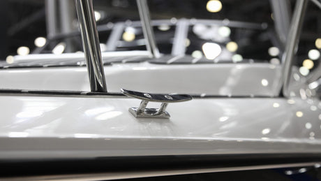 Fiberglass boat with a shiny finish after applying boat wax and polish in a marina setting outdoors