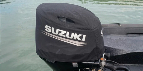 A close-up view of a covered Suzuki outboard boat motor.