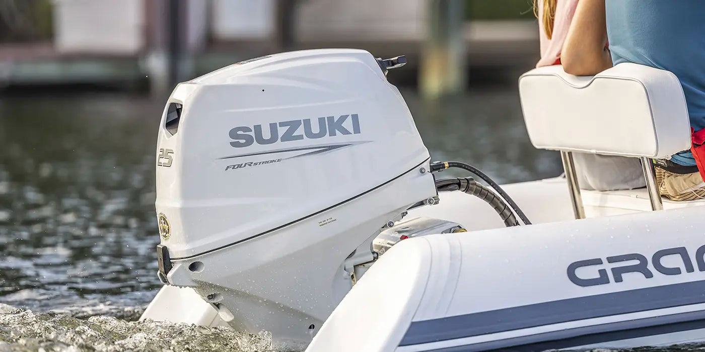 Suzuki 25HP four-stroke outboard motor powering an inflatable boat on the water