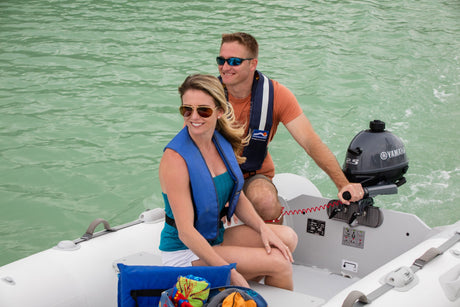 Yamaha small outboard motor being unboxed and prepared for mounting and initial operation demonstration